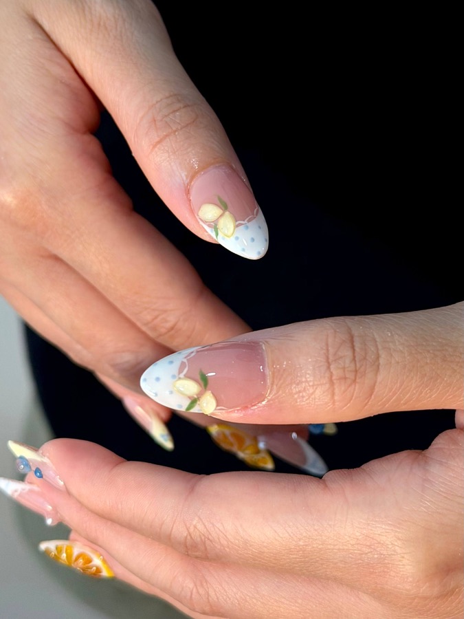 Close-up of a clean Russian manicure with a gold-leaf accent